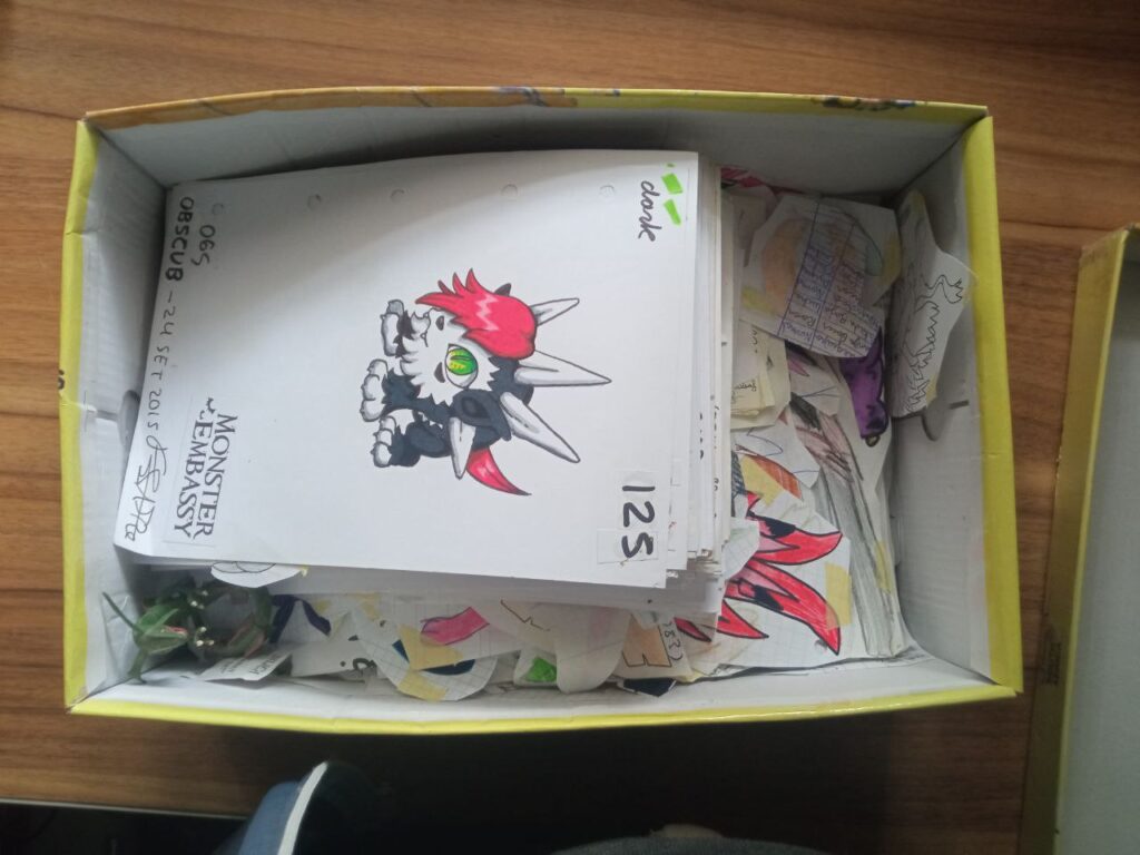 Picture of a box full of monster drawings.