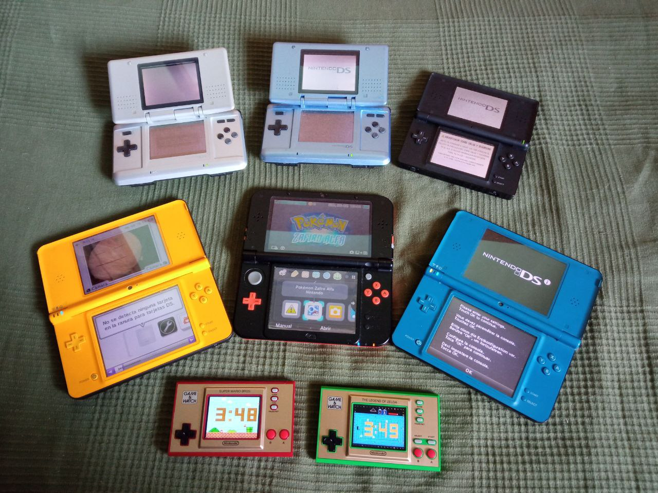 Collection of consoles including several Nintendo DS, a Nintendo 3DS and two Game and Watch